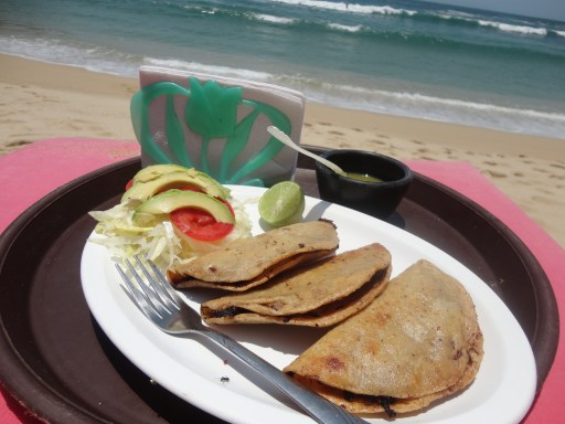 Greasy, though delicious fried fish tacos, on the beach