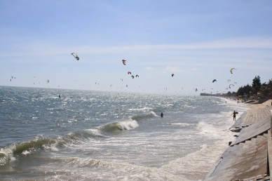 Wind surfers along Mui Ne beach