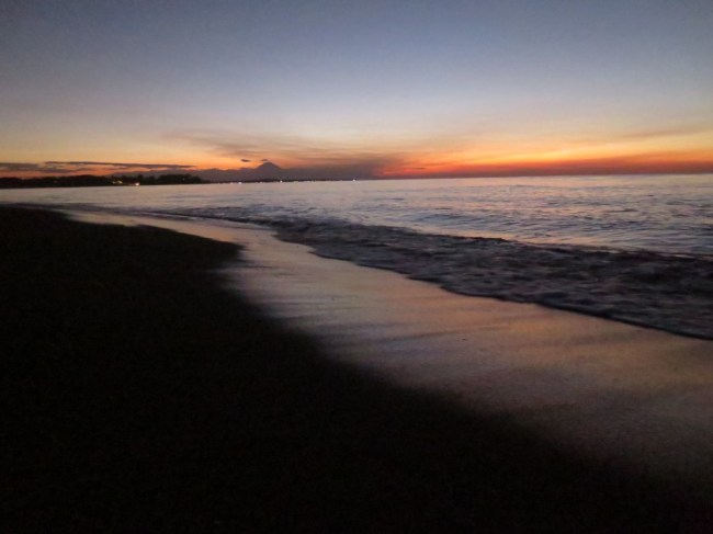Sunset over one of Lombok's volcanic black sand beaches